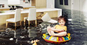 kid on flotation device in kitchen flooded with water